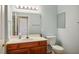 Bathroom featuring a single sink vanity with wooden cabinets and a framed mirror above the sink at 9303 Gilcrease Ave # 2178, Las Vegas, NV 89149