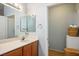 Bathroom features a single sink vanity, large mirror, and a toilet in a separate room at 9303 Gilcrease Ave # 2178, Las Vegas, NV 89149
