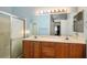 Bathroom features a double sink vanity, large mirror, tiled shower and modern fixtures at 9303 Gilcrease Ave # 2178, Las Vegas, NV 89149