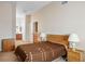 Bedroom features neutral walls, carpet, wood furniture and adjoins a bathroom and closet at 9303 Gilcrease Ave # 2178, Las Vegas, NV 89149