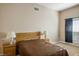 Bedroom with neutral walls, a wooden headboard, and a window with dark curtains at 9303 Gilcrease Ave # 2178, Las Vegas, NV 89149