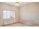 Neutral bedroom featuring a ceiling fan, a window with sheer curtains, and tan carpet at 9303 Gilcrease Ave # 2178, Las Vegas, NV 89149