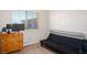 Bedroom with a dresser, futon, neutral walls, carpet, and window with blinds at 9303 Gilcrease Ave # 2178, Las Vegas, NV 89149