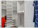 Walk-in closet with custom white shelving and hanging rods for optimal storage solutions at 9303 Gilcrease Ave # 2178, Las Vegas, NV 89149