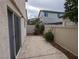Private backyard patio with stone-patterned concrete and side yard with neutral-colored fence at 10673 Alondra Peak St, Las Vegas, NV 89183