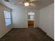 Comfortable carpeted bedroom with a ceiling fan and a view into the bathroom at 10673 Alondra Peak St, Las Vegas, NV 89183