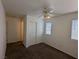 Neutral bedroom with a ceiling fan, carpet flooring, and windows for natural light at 10673 Alondra Peak St, Las Vegas, NV 89183