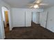 Spacious carpeted bedroom with a ceiling fan and multiple doors for easy access at 10673 Alondra Peak St, Las Vegas, NV 89183
