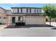 Two-story home with a two-car garage, desert landscaping, and a tile roof at 10673 Alondra Peak St, Las Vegas, NV 89183