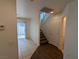 Hallway with tile flooring, stairs, a sliding glass door to the exterior, and white walls at 10673 Alondra Peak St, Las Vegas, NV 89183