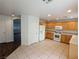 Bright kitchen with tile floors, wooden cabinets, and white appliances at 10673 Alondra Peak St, Las Vegas, NV 89183