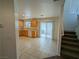 Open-concept kitchen with wood cabinets, tile floors, and sliding glass doors to the exterior at 10673 Alondra Peak St, Las Vegas, NV 89183