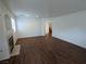 Spacious living room with wood floors, a fireplace, and an archway to the staircase at 10673 Alondra Peak St, Las Vegas, NV 89183