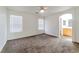 Spacious main bedroom with ceiling fan, neutral walls, carpet, and ensuite bath at 10673 Alondra Peak St, Las Vegas, NV 89183