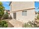 Outdoor patio with sliding glass door, window, and landscaping, perfect for relaxing at 10673 Alondra Peak St, Las Vegas, NV 89183