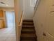 Carpeted staircase leading to the upper level with a window providing natural light at 10673 Alondra Peak St, Las Vegas, NV 89183