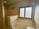 Bright bathroom with a walk-in shower, large window, soaking tub with jets, and a tile floor at 1210 Country Club, Laughlin, NV 89029