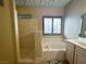 A bathroom featuring a walk-in shower, large window, soaking tub, and a vanity with drawers and cabinets at 1210 Country Club, Laughlin, NV 89029