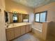Elegant bathroom featuring double sinks, a vanity and a soaking tub with tile surround at 1210 Country Club, Laughlin, NV 89029