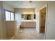 Bathroom featuring double vanity, walk-in closet and soaking tub with painted cloud ceiling at 1210 Country Club, Laughlin, NV 89029