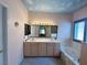 Elegant bathroom featuring double sinks, a vanity and a soaking tub with tile surround at 1210 Country Club, Laughlin, NV 89029