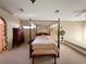 Spacious bedroom with a four-poster bed, carpet flooring, and a large window with natural light at 1210 Country Club, Laughlin, NV 89029