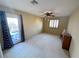 Bedroom with neutral walls, carpet, ceiling fan and access to a private outdoor space at 1210 Country Club, Laughlin, NV 89029
