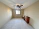 Bedroom with a ceiling fan, neutral walls, and a large window providing ample natural light at 1210 Country Club, Laughlin, NV 89029