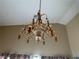 Ornate chandelier features crystal accents and gold framework, adding elegance to the room at 1210 Country Club, Laughlin, NV 89029