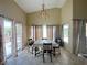 Chandelier illuminates this dining area with a floral tablecloth and sliding doors to the backyard at 1210 Country Club, Laughlin, NV 89029