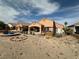 Wide view of a single-story home with desert landscaping and a covered patio at 1210 Country Club, Laughlin, NV 89029