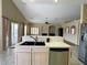 Open kitchen with tile countertops and stainless steel appliances, flowing into the living area at 1210 Country Club, Laughlin, NV 89029