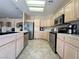 Bright kitchen boasts stainless steel appliances, tile floors, and ample cabinet space at 1210 Country Club, Laughlin, NV 89029