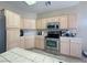 Bright kitchen boasts stainless steel appliances, tile floors, and ample cabinet space at 1210 Country Club, Laughlin, NV 89029