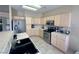 Bright kitchen boasts stainless steel appliances, tile floors, and ample cabinet space at 1210 Country Club, Laughlin, NV 89029