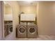 Convenient laundry room featuring modern washer and dryer units with built-in cabinets at 1210 Country Club, Laughlin, NV 89029