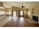 Open-concept living room featuring wood floors, fireplace, vaulted ceiling, and access to the backyard at 1210 Country Club, Laughlin, NV 89029