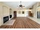 Bright living room features wood floors, fireplace, ceiling fan and archways to other rooms at 1210 Country Club, Laughlin, NV 89029