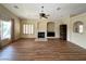 Spacious living room with a fireplace, wood floors, and neutral colors at 1210 Country Club, Laughlin, NV 89029