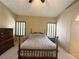 Bedroom with neutral carpet, shuttered windows, and dark wood furnishings at 1210 Country Club, Laughlin, NV 89029