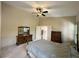 Large bedroom with neutral carpet, wood furniture and adjacent entry to bath and walk-in closet at 1210 Country Club, Laughlin, NV 89029