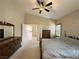 Spacious bedroom with neutral carpet and dark wood furnishings adjacent to bath and walk-in closet at 1210 Country Club, Laughlin, NV 89029