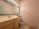 Powder room with a vintage vanity, framed mirror, and decorative floral accents at 1210 Country Club, Laughlin, NV 89029