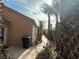 A side view reveals a well-maintained walkway, desert plants, and the exterior of the house at 1210 Country Club, Laughlin, NV 89029