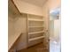 Walk-in closet with built-in shelving and wooden racks for ample storage at 1210 Country Club, Laughlin, NV 89029