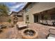Charming backyard with a fire pit, patio furniture, and playhouse at 12495 Point Sierra St, Las Vegas, NV 89138