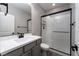 Bathroom featuring modern vanity, frameless shower, and sleek black fixtures at 12495 Point Sierra St, Las Vegas, NV 89138