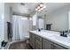 Bathroom with double vanity, modern fixtures, and shower-tub combination under a well-lit mirror at 12495 Point Sierra St, Las Vegas, NV 89138