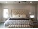 Comfortable bedroom with a large bed, upholstered headboard, and neutral decor for a relaxing atmosphere at 12495 Point Sierra St, Las Vegas, NV 89138