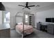 Bright bedroom featuring a cute bed, ceiling fan, and neutral decor at 12495 Point Sierra St, Las Vegas, NV 89138
